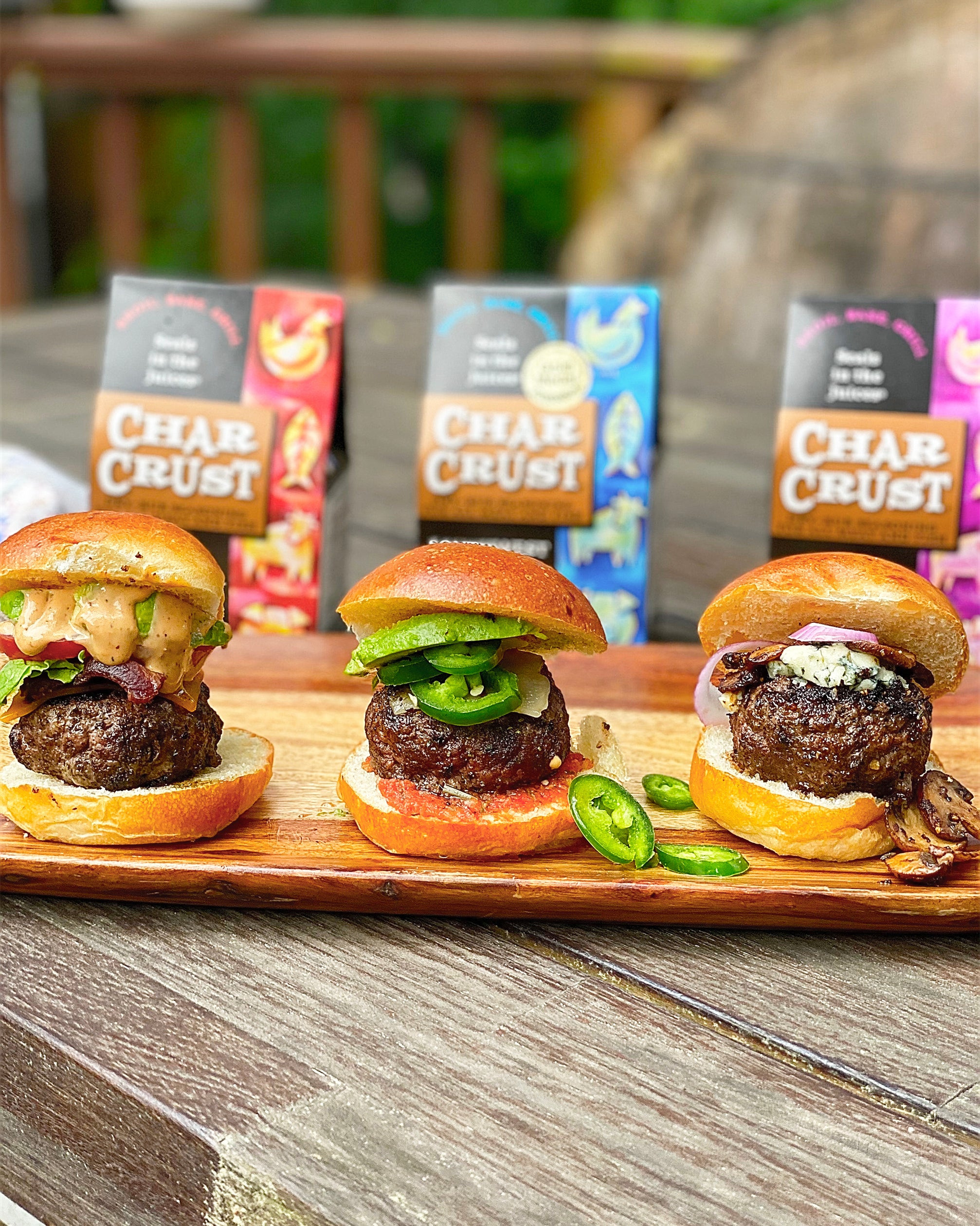 Char Crust Sliders with different toppings and sauces. Packages of multiple flavors in the background.
