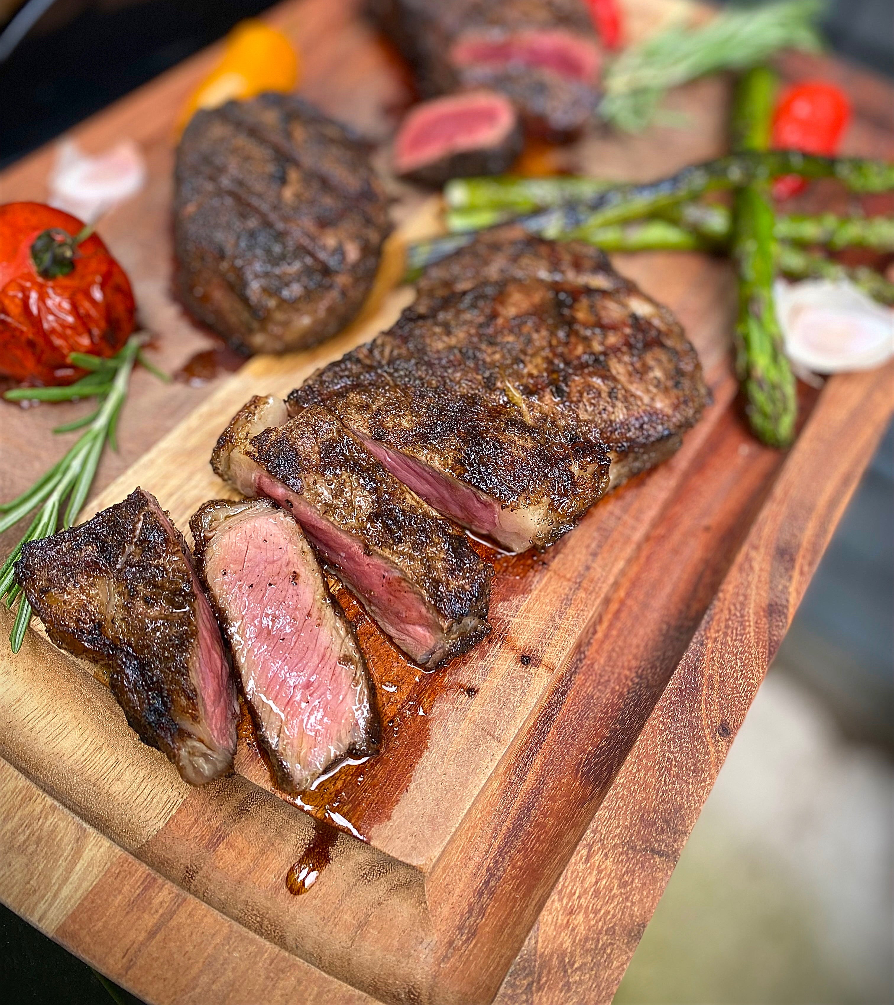 Sliced Char-Crusted® steak on cutting board with